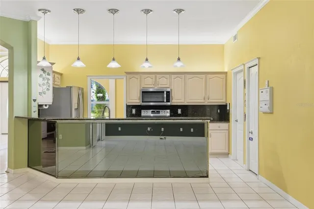 a kitchen with granite countertop a sink and a stove