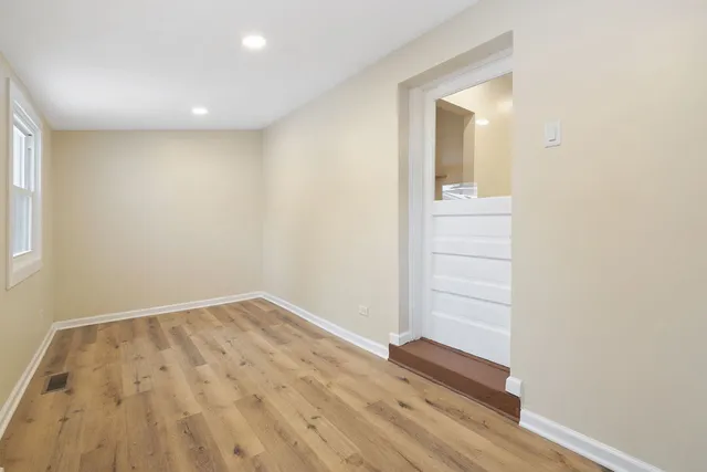 an empty room with wooden floor and closet