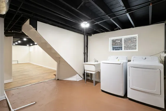 a view of storage and utility room with washer and dryer