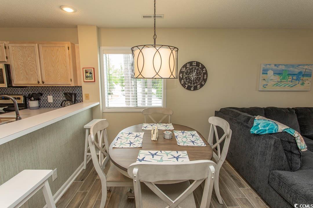 201 Landing Road, Unit D North Myrtle Beach, SC 29582 - Photo 9 of 40 Dining space with recessed lighting, wood finish floors, visible vents, and baseboards