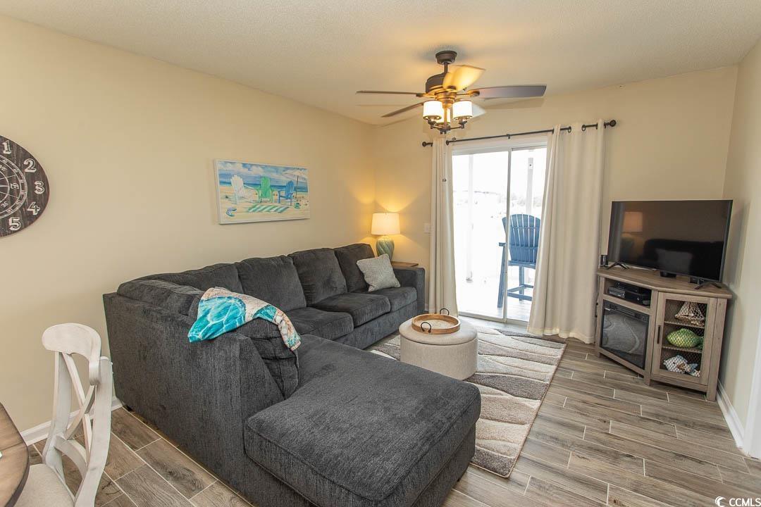201 Landing Road, Unit D North Myrtle Beach, SC 29582 - Photo 10 of 40 Living area with baseboards, a ceiling fan, and wood tiled floor