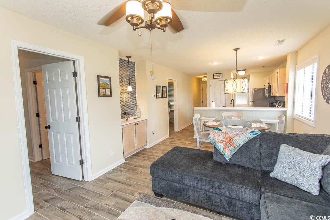 201 Landing Road, Unit D North Myrtle Beach, SC 29582 - Photo 13 of 40 Living area with baseboards, a ceiling fan, visible vents, and light wood-style flooring