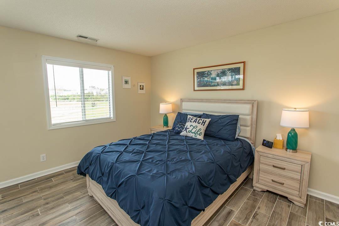 201 Landing Road, Unit D North Myrtle Beach, SC 29582 - Photo 15 of 40 Bedroom with wood finish floors, visible vents, and baseboards