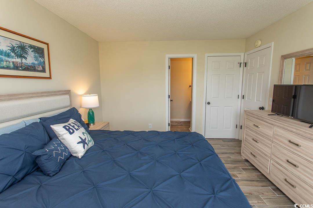 201 Landing Road, Unit D North Myrtle Beach, SC 29582 - Photo 18 of 40 Bedroom with a textured ceiling and dark wood finished floors
