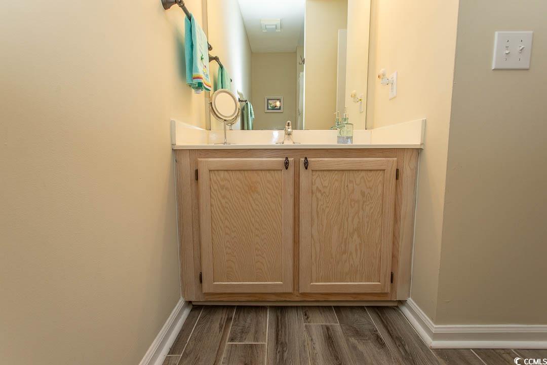 201 Landing Road, Unit D North Myrtle Beach, SC 29582 - Photo 21 of 40 Bathroom featuring wood finished floors, vanity, and baseboards