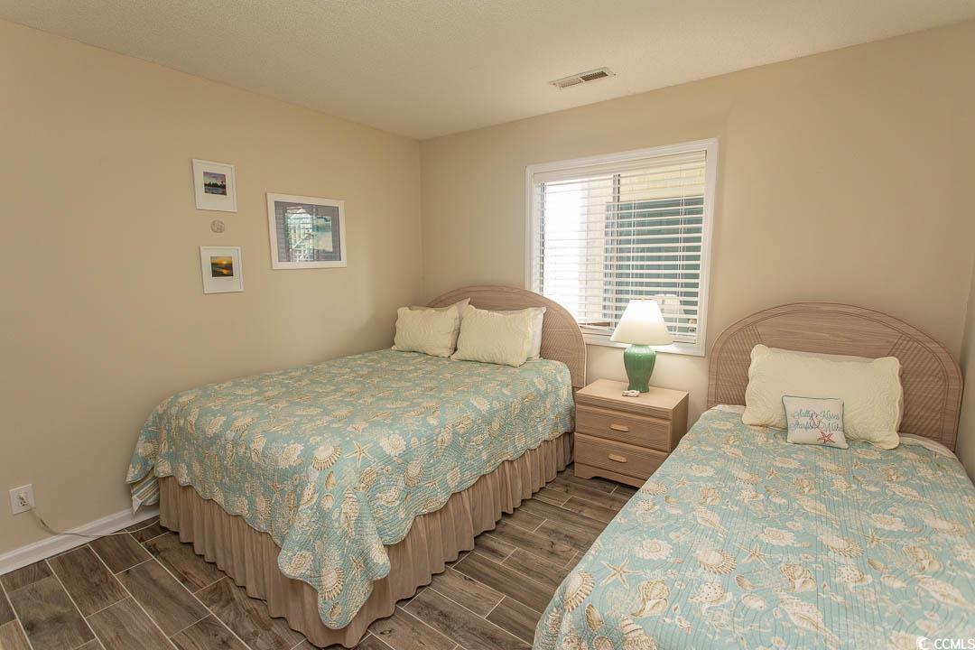 201 Landing Road, Unit D North Myrtle Beach, SC 29582 - Photo 23 of 40 Bedroom featuring wood tiled floor, visible vents, and baseboards