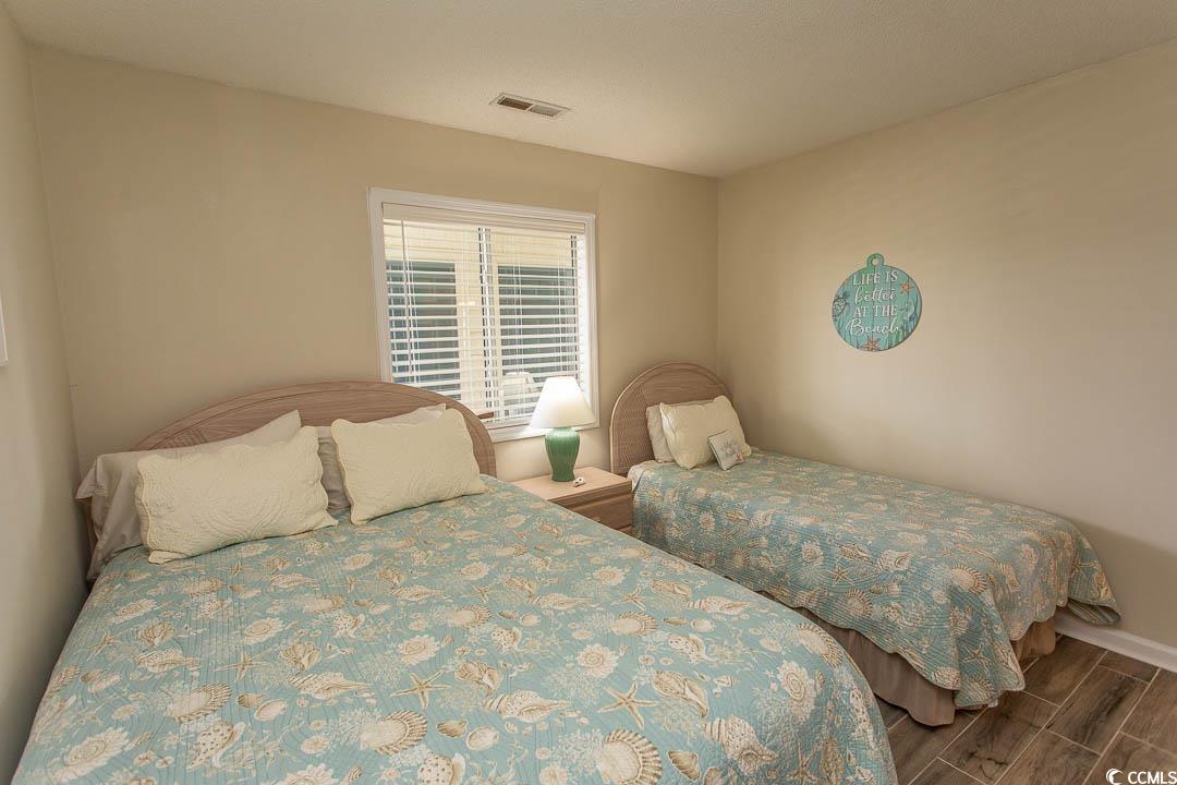 201 Landing Road, Unit D North Myrtle Beach, SC 29582 - Photo 25 of 40 Bedroom featuring wood finish floors, baseboards, and visible vents