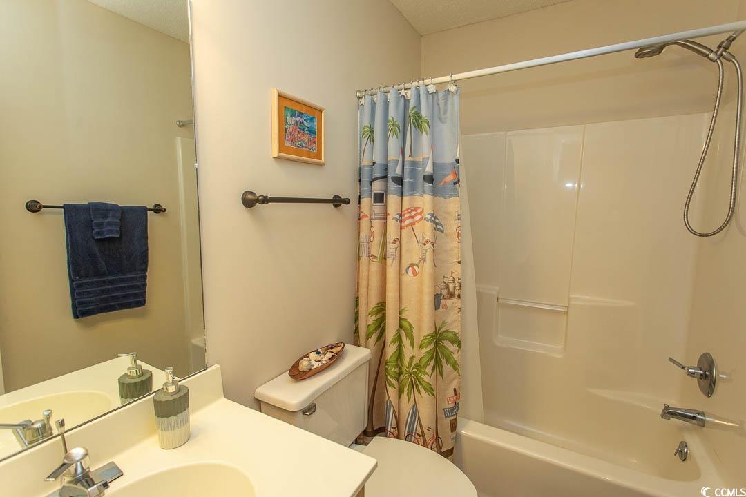 201 Landing Road, Unit D North Myrtle Beach, SC 29582 - Photo 28 of 40 Full bathroom featuring vanity, shower / bathtub combination with curtain, and toilet