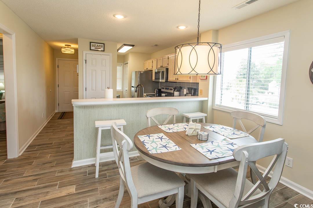 201 Landing Road, Unit D North Myrtle Beach, SC 29582 - Photo 3 of 40 Dining area with recessed lighting, a wealth of natural light, baseboards, and dark wood-style flooring