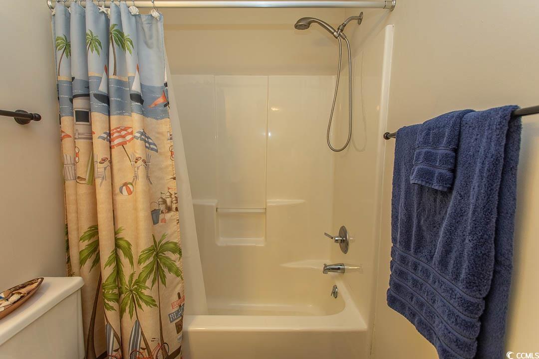 201 Landing Road, Unit D North Myrtle Beach, SC 29582 - Photo 29 of 40 Full bath featuring shower / bathtub combination with curtain and toilet