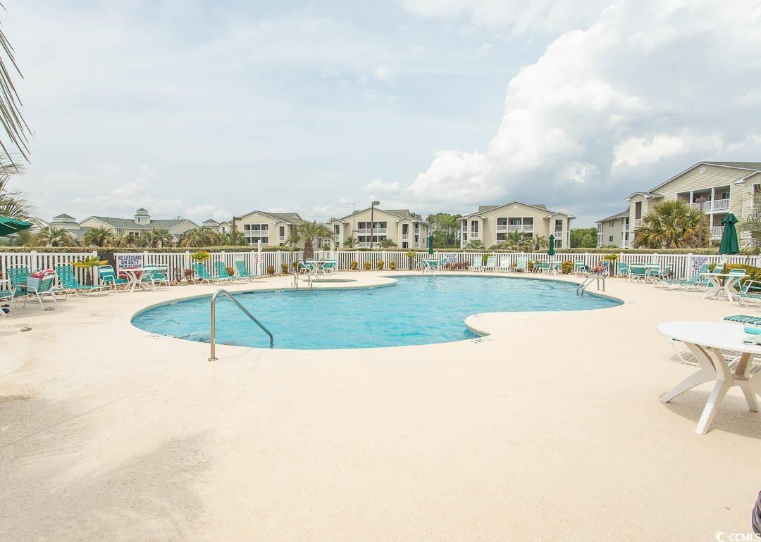 201 Landing Road, Unit D North Myrtle Beach, SC 29582 - Photo 34 of 40 Pool featuring fence, a patio area, and a residential view