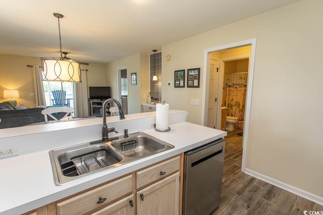 201 Landing Road, Unit D North Myrtle Beach, SC 29582 - Photo 40 of 40 Kitchen with light brown cabinetry, stainless steel dishwasher, a sink, open floor plan, and dark wood-style flooring