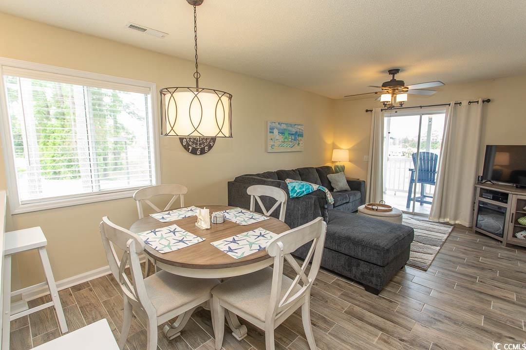 201 Landing Road, Unit D North Myrtle Beach, SC 29582 - Photo 8 of 40 Dining room featuring ceiling fan, baseboards, visible vents, and wood tiled floor
