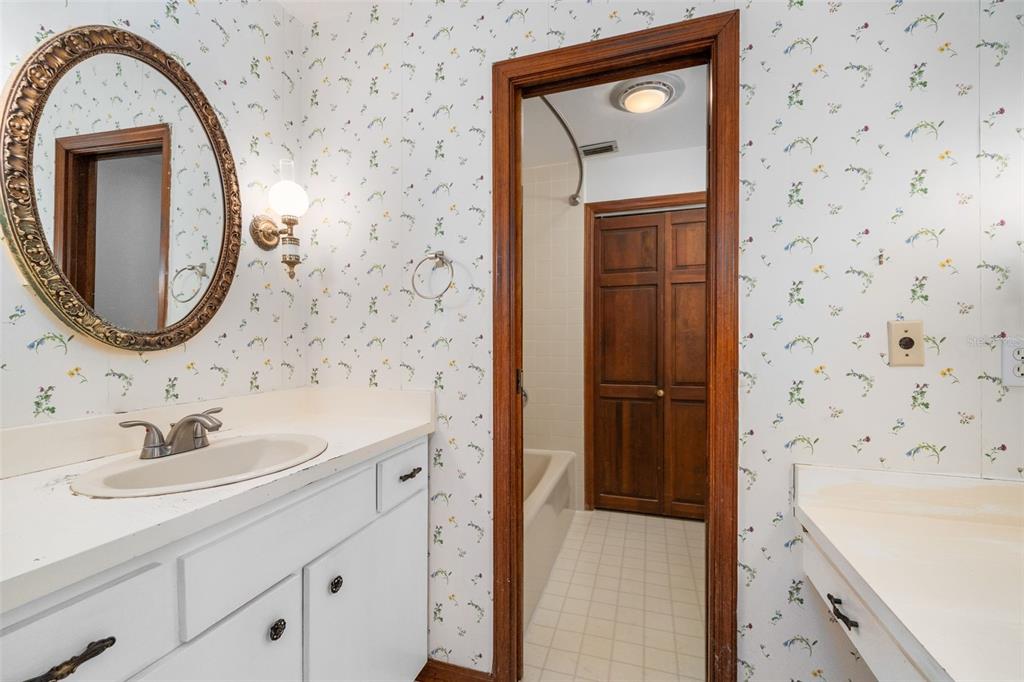 4703 Northwest 124th Street Gainesville, FL 32606 - Photo 28 of 55 a bathroom with a sink a mirror and a shower
