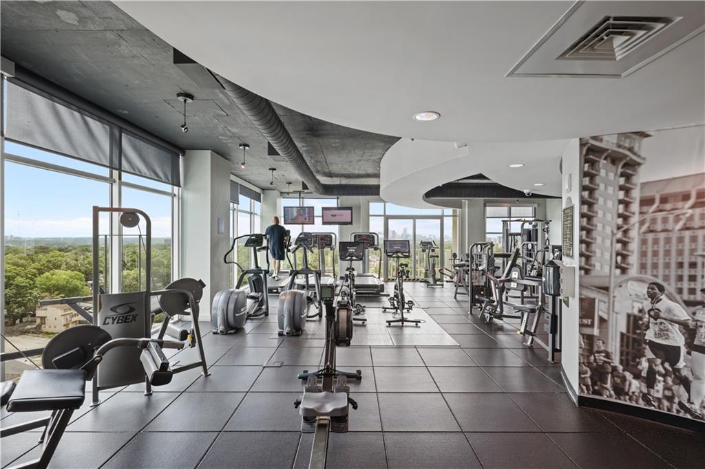 250 Pharr Road Northeast, Unit 606 Atlanta, GA 30305 - Photo 19 of 31 a room with lots of chairs and mirrors