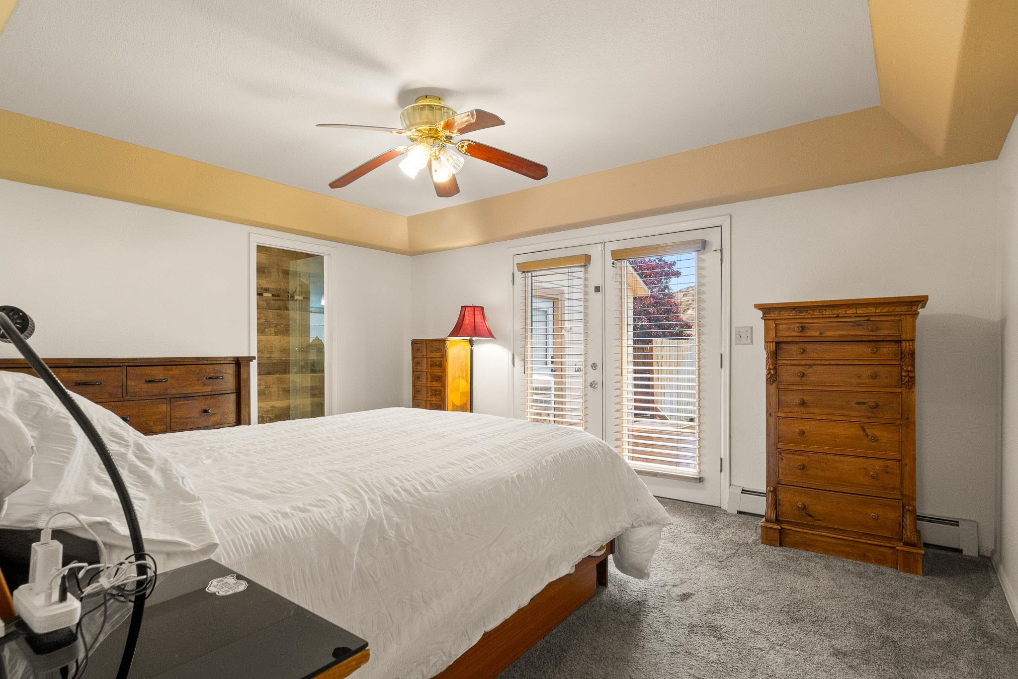 398 Butte Court Grand Junction, CO 81507 - Photo 11 of 33 a bedroom with a bed and a chandelier