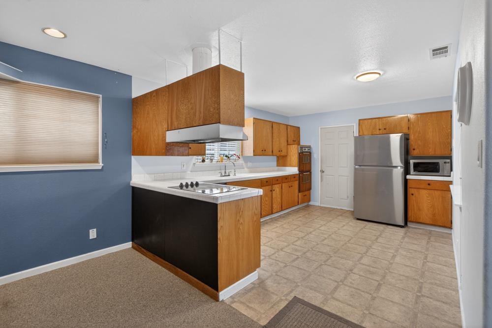7213 Coronet Court Citrus Heights, CA 95621 - Photo 13 of 52 a kitchen with stainless steel appliances granite countertop a stove a refrigerator and a sink