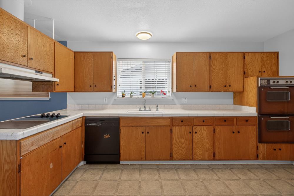 7213 Coronet Court Citrus Heights, CA 95621 - Photo 14 of 52 a kitchen with a sink window and cabinets
