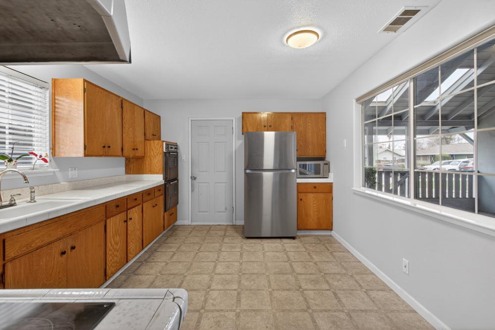 7213 Coronet Court Citrus Heights, CA 95621 - Photo 18 of 52 a kitchen with a refrigerator and a sink