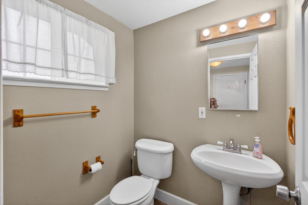 7213 Coronet Court Citrus Heights, CA 95621 - Photo 21 of 52 a bathroom with a sink a mirror and a toilet