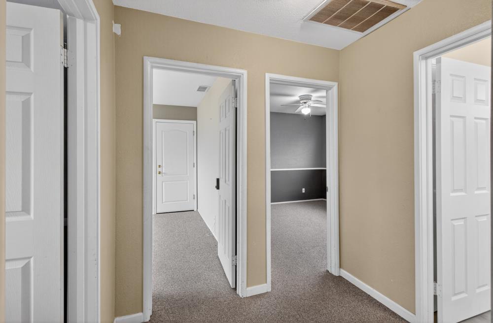 7213 Coronet Court Citrus Heights, CA 95621 - Photo 24 of 52 a view of a hallway with wooden shelves