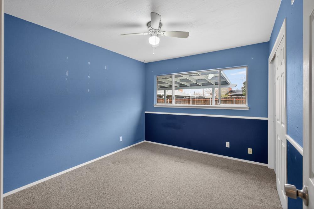 7213 Coronet Court Citrus Heights, CA 95621 - Photo 25 of 52 an empty room with windows and ceiling fan