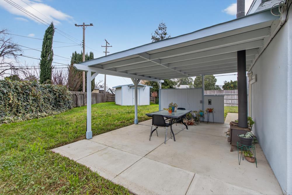 7213 Coronet Court Citrus Heights, CA 95621 - Photo 39 of 52 a view of a patio with table and chairs potted plants with wooden fence