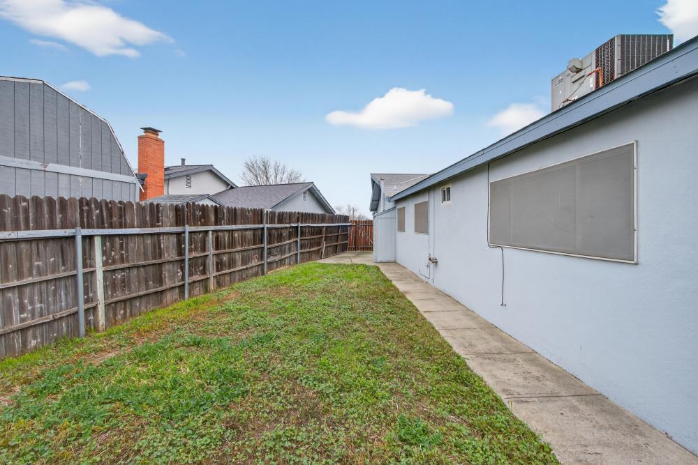 7213 Coronet Court Citrus Heights, CA 95621 - Photo 45 of 52 a view of a backyard with wooden fence and two windows