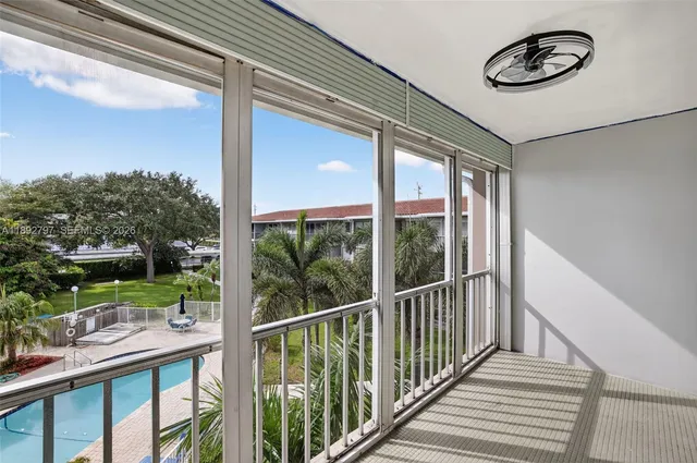 a kitchen with granite countertop a sink and white cabinets