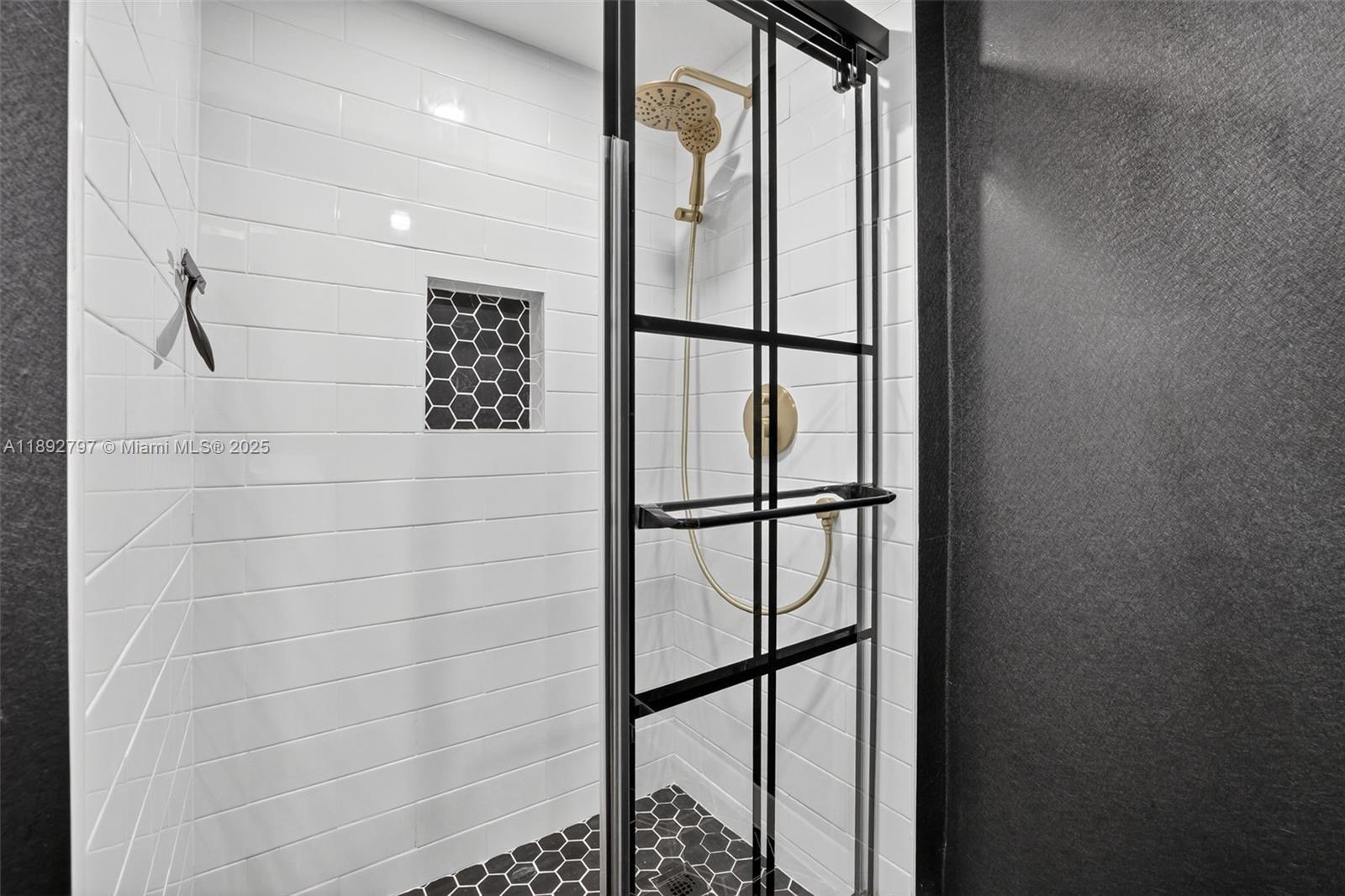 900 Southwest 12th Street, Unit 305 Fort Lauderdale, FL 33315 - Photo 37 of 72 Super cool updated primary bathroom with glass shower enclosure, subway tile, handheld shower head, shampoo niche box