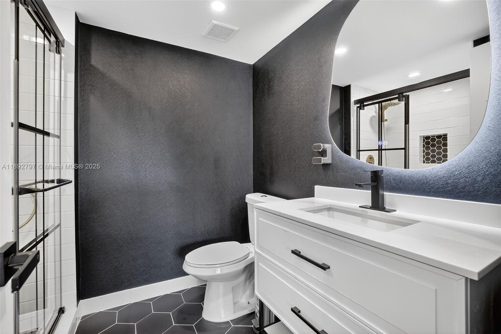 900 Southwest 12th Street, Unit 305 Fort Lauderdale, FL 33315 - Photo 6 of 72 Super cool updated primary bathroom with glass shower enclosure, floating vanity, high hat lighting, backlit mirror