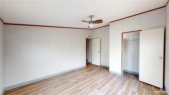 a bathroom with a toilet sink vanity and mirror