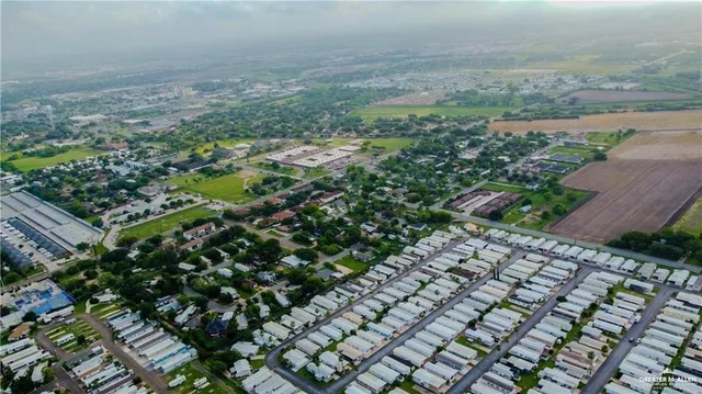 an aerial view of residential house with an outdoor space and seating