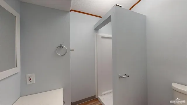 a bathroom with a toilet and a shower