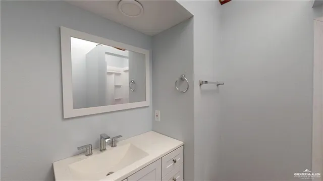 a bathroom with a sink and mirror