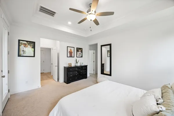 a bedroom with a large bed and a chandelier