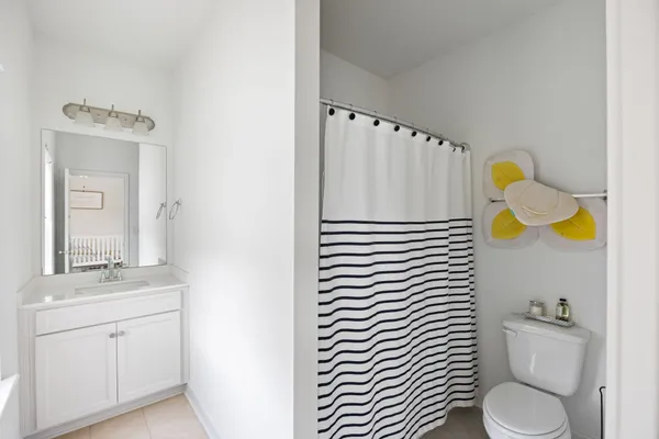a bathroom with a sink mirror vanity and toilet
