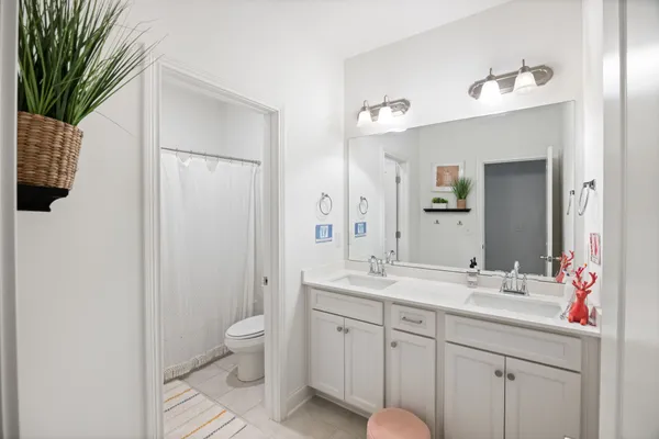 a spacious bathroom with a granite countertop sink mirror and toilet