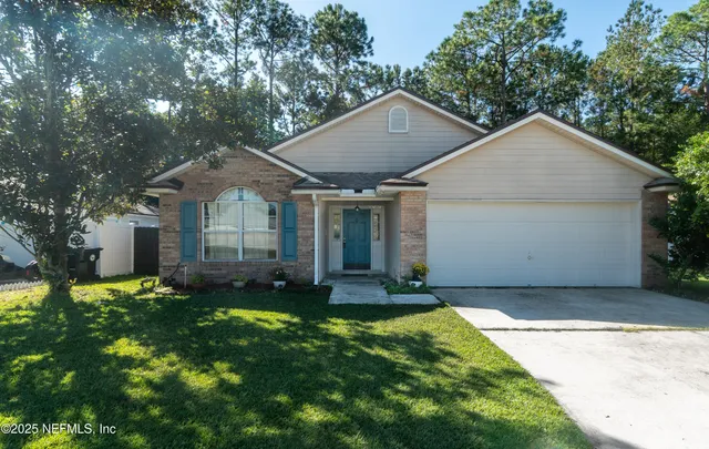 a front view of a house with a yard and garage