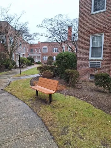 a view of a chairs in backyard of house