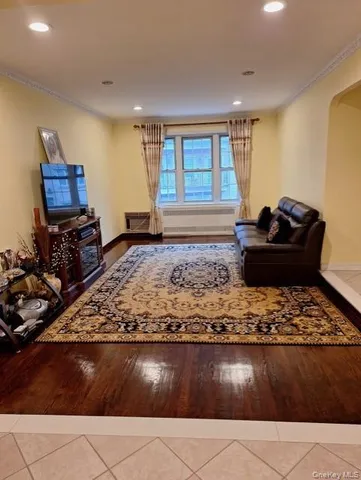 a living room with hard wood flooring and a couch