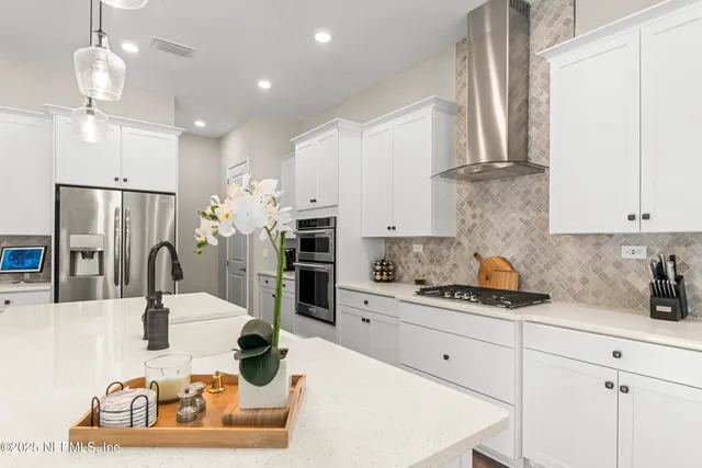 a kitchen with stainless steel appliances kitchen island granite countertop a sink and cabinets