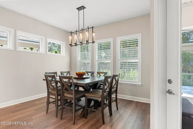 a large kitchen with stainless steel appliances kitchen island granite countertop a sink and a refrigerator