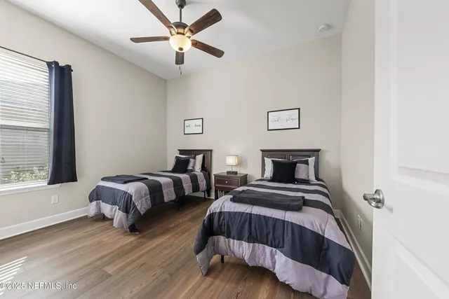 a bathroom with a granite countertop sink a toilet and a shower