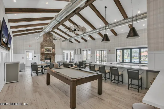 a kitchen with a table chairs refrigerator and cabinets