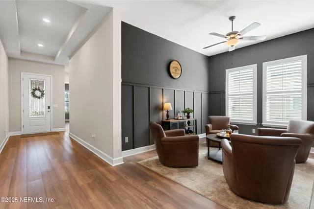 a view of a livingroom with furniture window and wooden floor