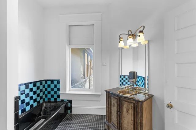 a bathroom with a sink a mirror and a window