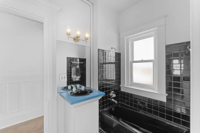 a bathroom with a sink and a washing machine