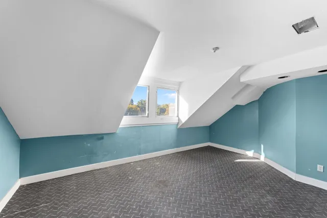 a view of a room that has a glass door and a window