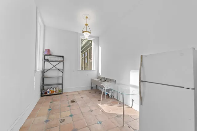 a view of a livingroom with furniture and a window